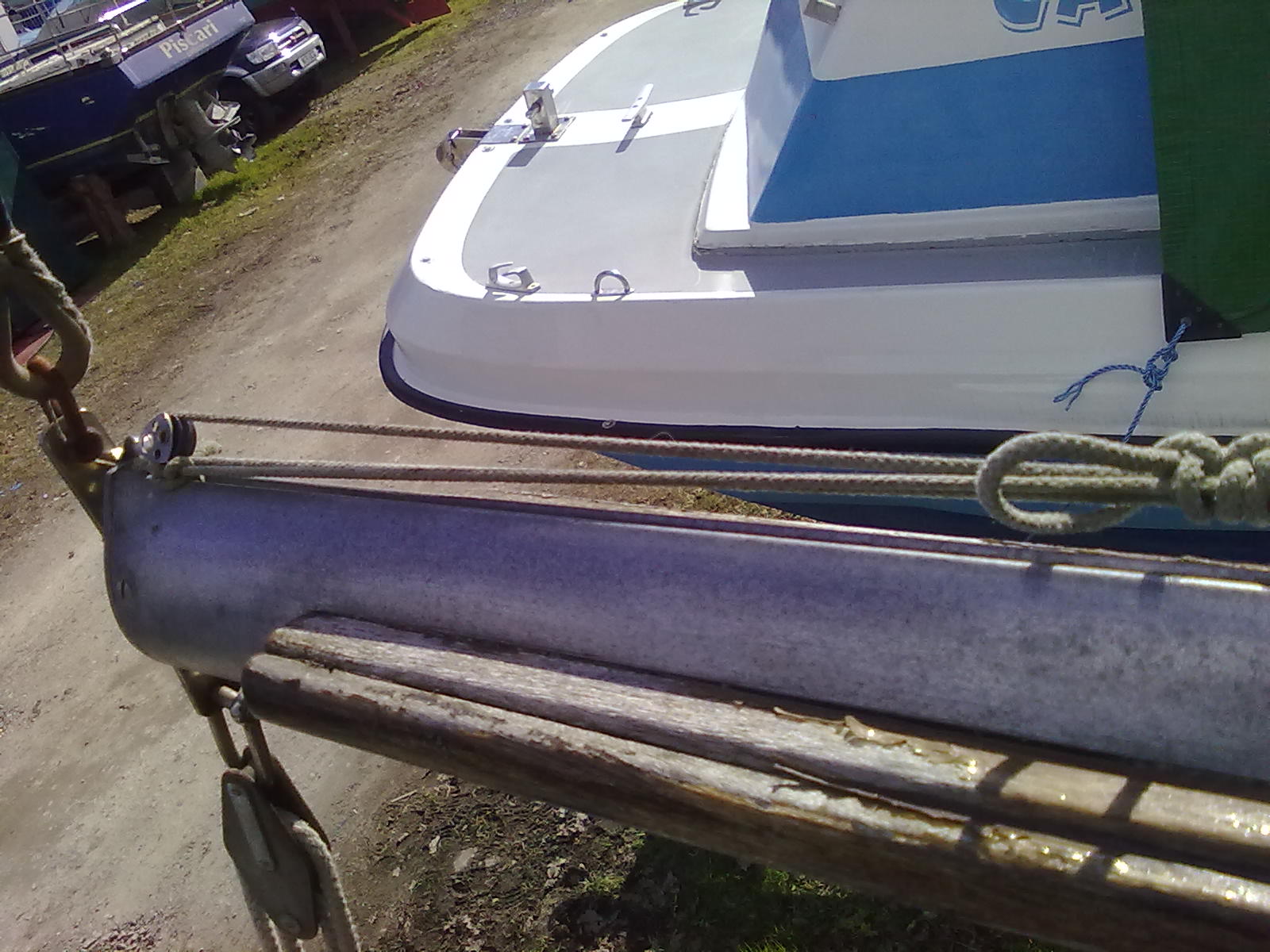 boom aft end, showing tensioning block, peeling varnish only there